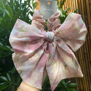 Detailed view of large pink floral chiffon scrunchie with a big matching bow tie