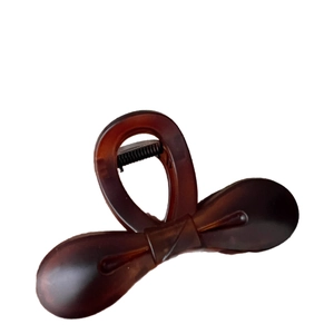 Elegant 10.5cm brown bow hair claw clip with a sleek translucent finish on white background