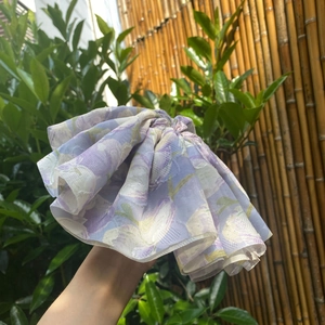 Close-up of oversized purple floral organza scrunchie with layered pleated details