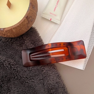 Detail of hollow rectangular hair claw clip with classic amber tortoiseshell pattern