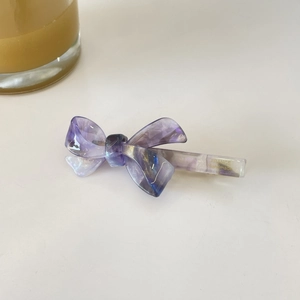 Barrette à cheveux nœud en acétate violet étoilé avec des paillettes dorées