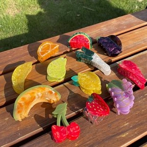 Outdoor shot of assorted acetate fruit hair clips including strawberry and lemon styles