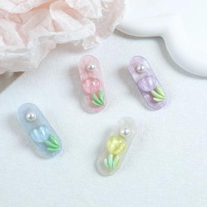 Detailed set of four pastel tulip and pearl hair clips in blue, pink, purple, and yellow