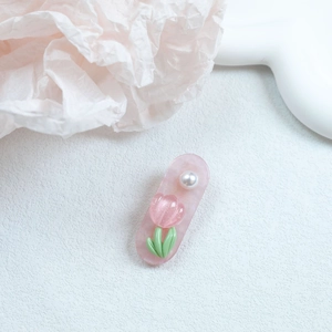 Detail of pink marble tulip hair clip with delicate glitter and white pearl accent