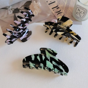 Large acetate claw clips set with elegant marble texture and artistic ink patterns