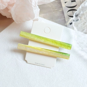 Duo set of long marbled acetate hair clips in fresh green and yellow gradient tones