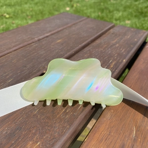 Iridescent cloud-shaped hair claw clip in candy green with wavy edges and metal spring
