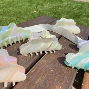 Detailed macro view of colorful cloud shaped acetate hair clips with pearlescent finish