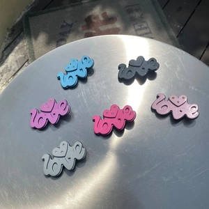 Top view of Y2K style LOVE hair clips with rhinestones in six vibrant candy colors