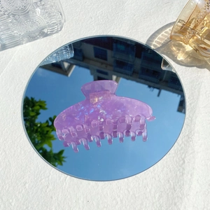 Detailed view of large purple iridescent acetate hair claw clip with holographic glitter finish