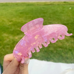 Macro shot of large translucent pink purple glitter claw clip with gradient effect