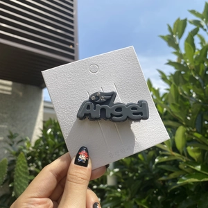 Close-up of Y2K Angel hair clip with rhinestones on a white display card