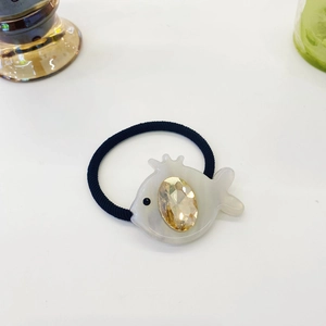 Detail of Korean style elastic hair tie with white fish charm and yellow crystal gem