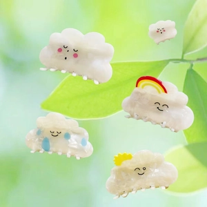 Detailed set of five acetic acid cloud hair clips with rainbow and sun drops on green leaves