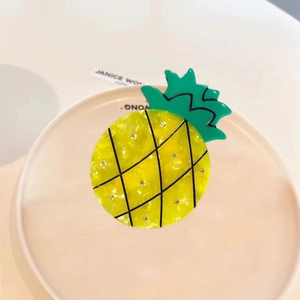 Cute pineapple hair claw clip made of yellow acetate with green leaf design for women