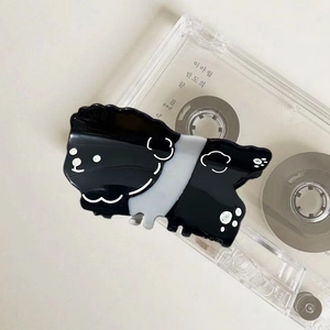 Cute black and white puppy hair claw clip made of acetate with a vintage aesthetic look