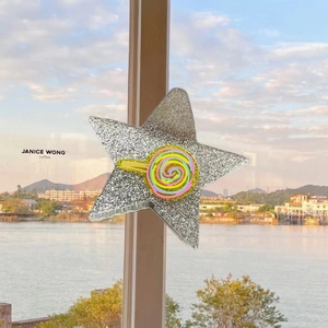 Sparkly silver star hair claw with a colorful lollipop charm for a dopamine style look