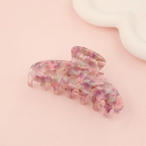 Pink and purple floral acetate claw clip on aesthetic background for summer hairstyles