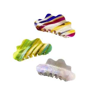 Three colorful cloud-shaped acetate hair claws in striped and pearlescent pastel patterns
