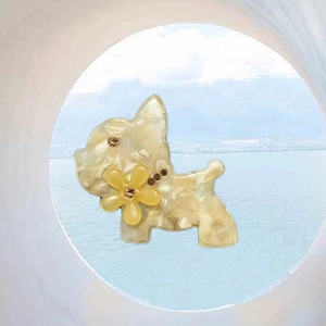 Detail of French Bulldog acetate hair clip with marble texture and yellow flower