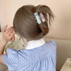 Chic two-piece sugar cube hair clips in pink plaid and marble blue on styled hair