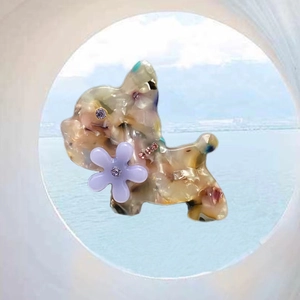 Detailed macro view of French Bulldog hair clip crafted from marbled acetate with purple crystals