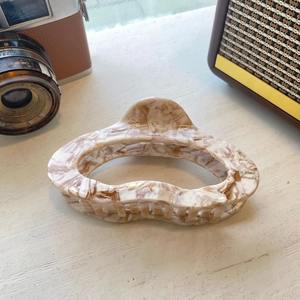 Elegant large cloud acetate hair claw clip with beige marble texture and glossy finish