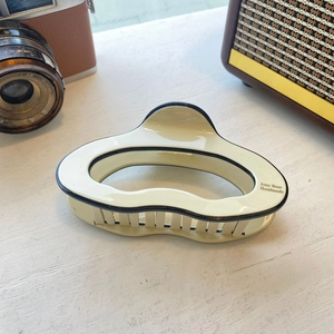 Detailed view of Amy Bear handmade acetate hair claw clip with cream and black contrast design