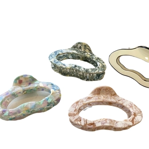 Large cloud acetic acid hair claws in marble and floral textures with logo detail