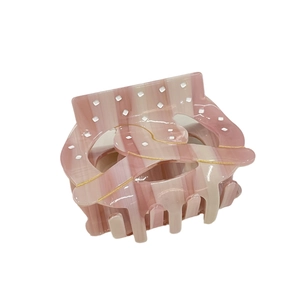 Pink striped acetate hair claw clip with gold accents and marble pattern for women
