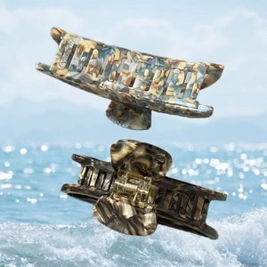 Detail showing marble texture and tortoiseshell patterns on acetate shark hair clips