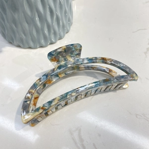 Blue and yellow acetate moon-shaped hair claw clip with marble texture for thick hair