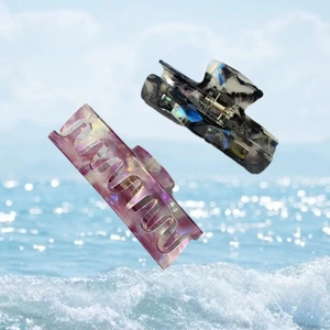Detail view of acetate claw clips with floral patterns and marble texture set