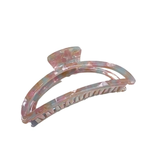 Elegant moon-shaped acetate hair claw clip with colorful marble pattern on white background