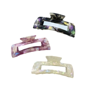 Three-piece acetate hair claw clip set with marble, purple, and pearlescent patterns