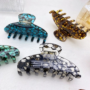 Elegant large acetate claw clips in tortoiseshell and marble patterns with metal spring