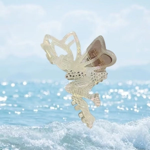 Detailed macro view of pearlescent acetate butterfly hair claw clip with rhinestones