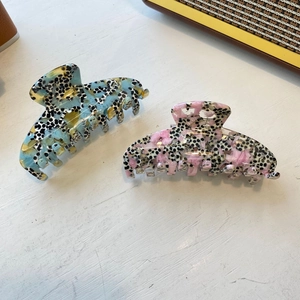 Pink and blue dragon fruit pattern acetate hair claws for women on white surface