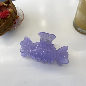 Cute purple candy-shaped acetate hair claw clip for women on a white background