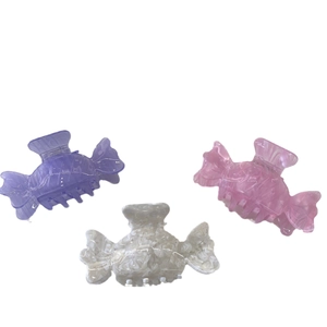 Colorful candy-shaped acetate hair claws with elegant marble texture and round teeth
