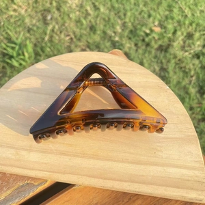 Detail of amber tortoiseshell triangle hair claw clip with strong metal spring