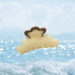 Cloud-shaped acetate hair claw in cream and caramel brown with sun flower pattern