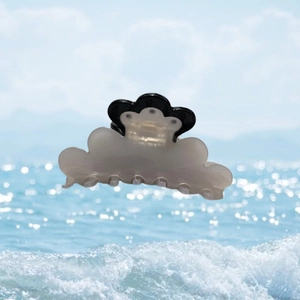 Cloud-shaped acetate hair claw clip with sunflower and rhinestone detail on sea background