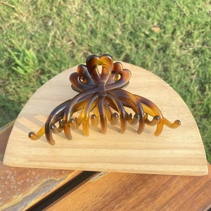 Close-up of heart-shaped tortoiseshell hair claw clip with amber gradient resin detail