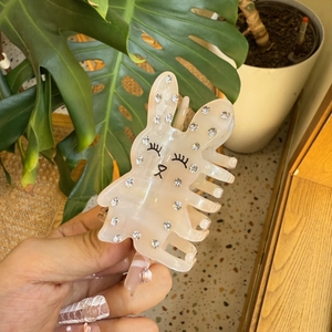 Pince à cheveux lapin en acétate avec strass et finition nacrée soyeuse tenue à la main