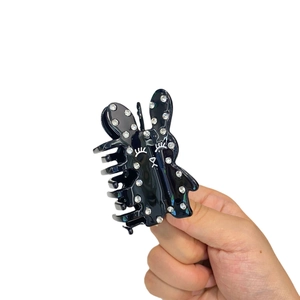 Pince à cheveux lapin noir en acétate avec strass brillants et design de visage souriant
