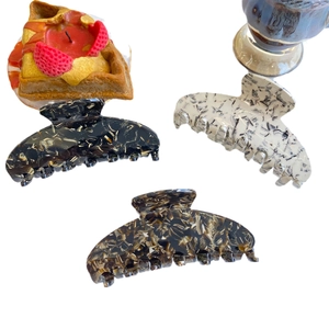 Three-piece acetate claw clip set in tortoiseshell and marble patterns for elegant hair styling