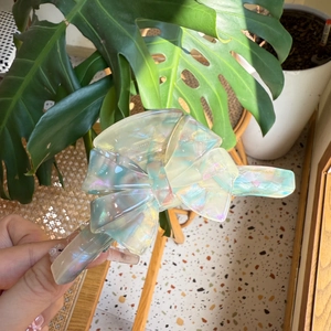 Iridescent acetate bow hair claw clip with colorful star-like shimmer for women