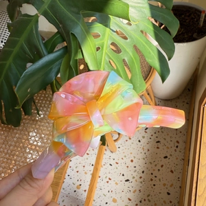Macro shot of large acetate hair claw clip with colorful iridescent bow design