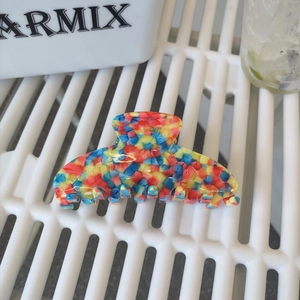 Large acetate hair claw clip with colorful mosaic texture and artistic ribbon pattern